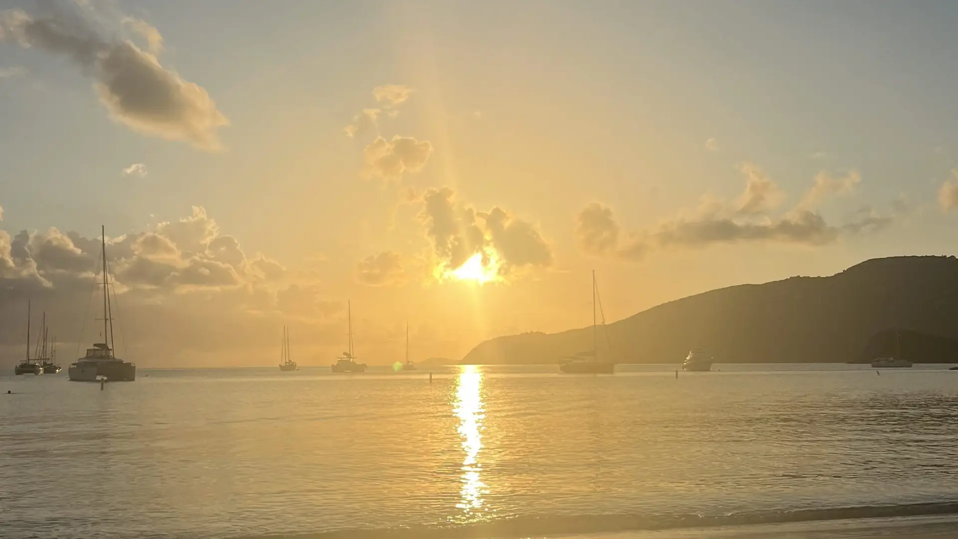 Sunset over the serene waters of St. Thomas, symbolizing the end of a day and reflecting on the emotional journey of coping with loss and life after cancer