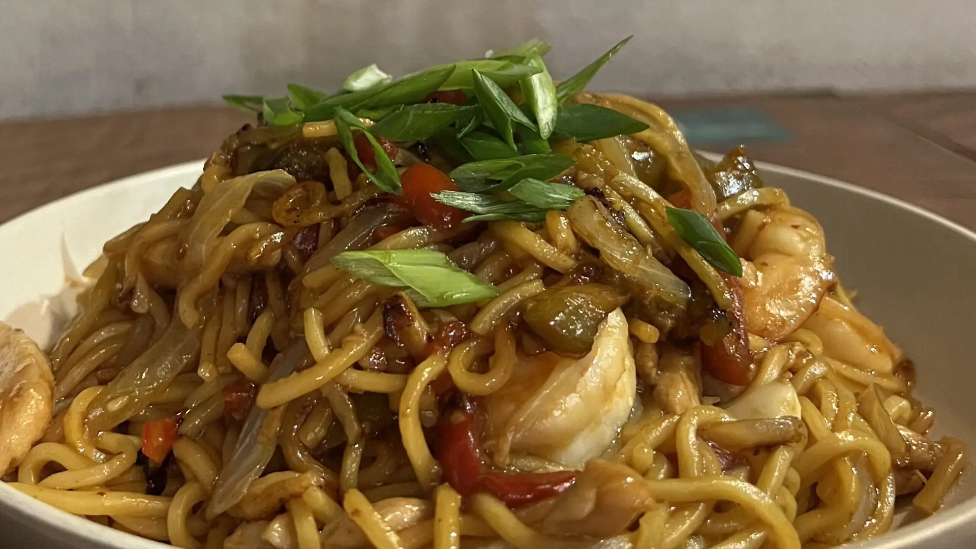 Shrimp and chicken chow mein at The Refinery in St. John, featuring vibrant vegetables and savory flavors in a beautifully presented dish.