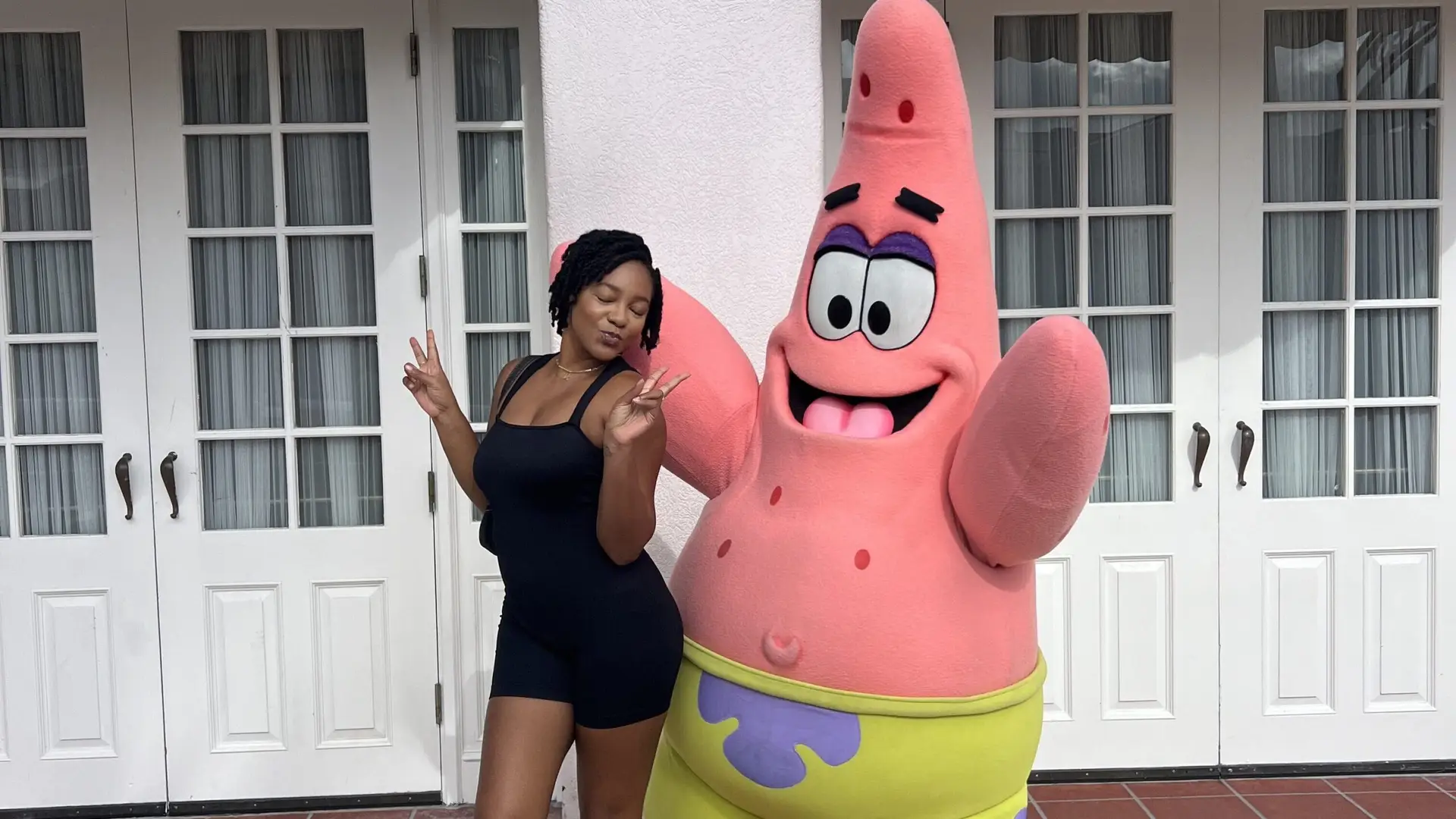 Enjoying the quarter life crisis journey at Universal Studios with Patrick Star, embracing fun and memorable moments at 25.