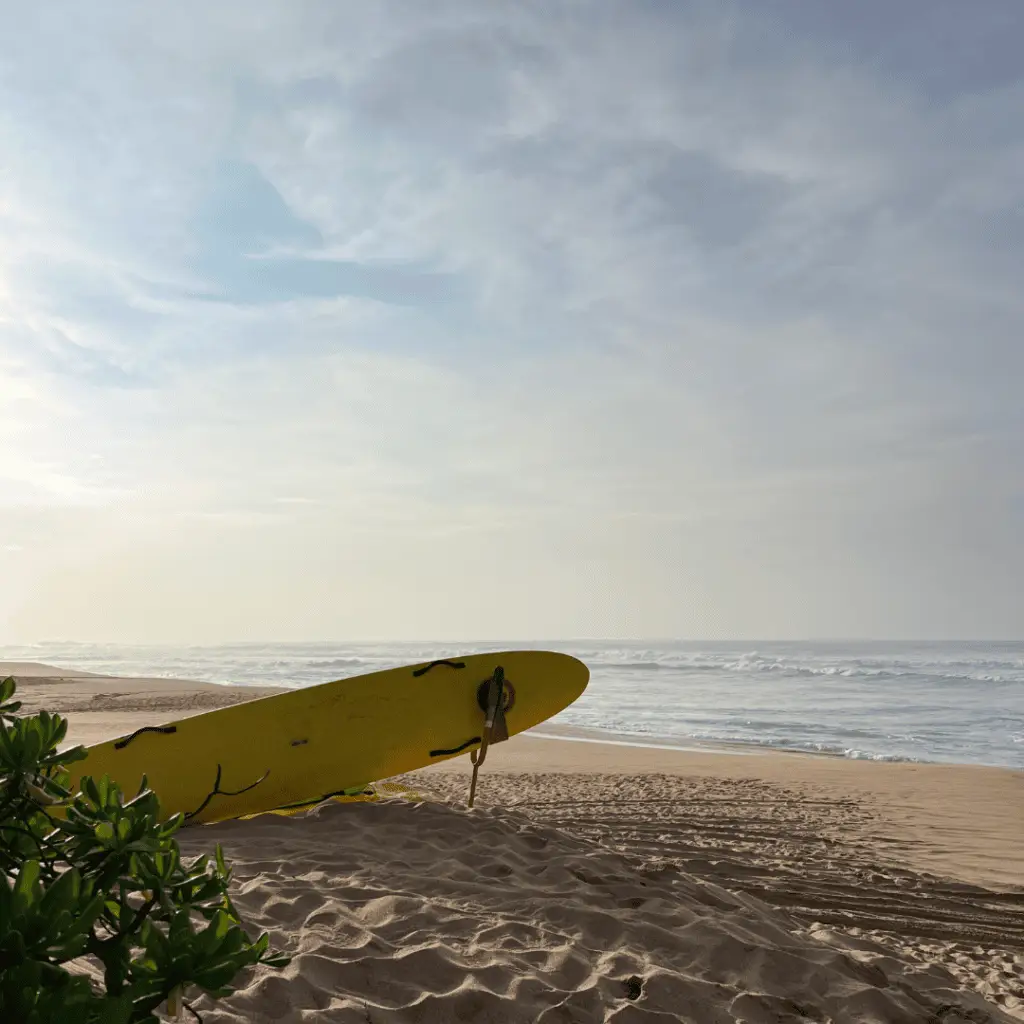 Beach and surfboard symbolizing the Caribbean travel guide digital product